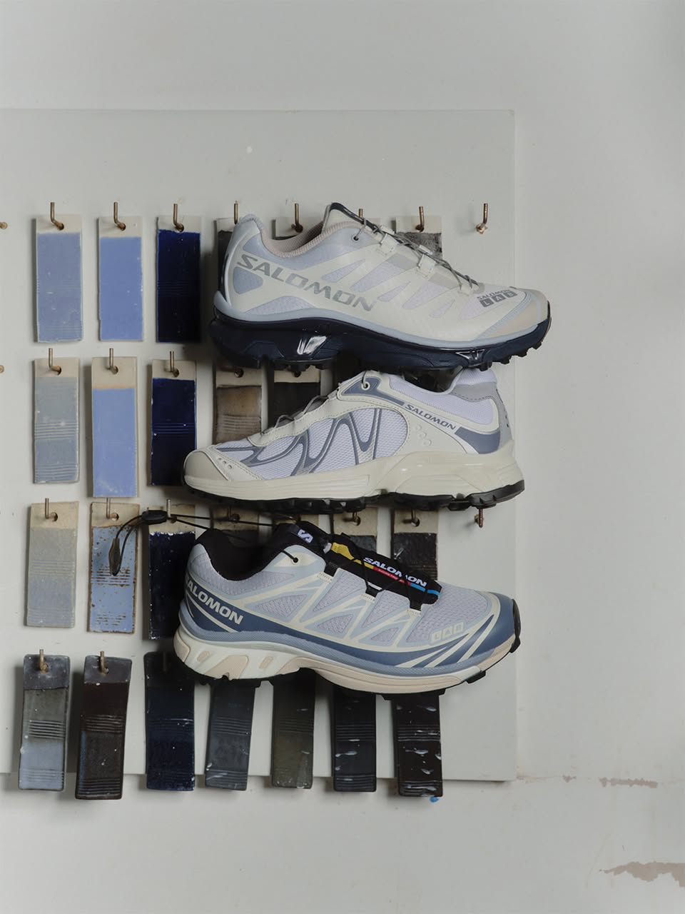 Salomon running shoes on wall rack