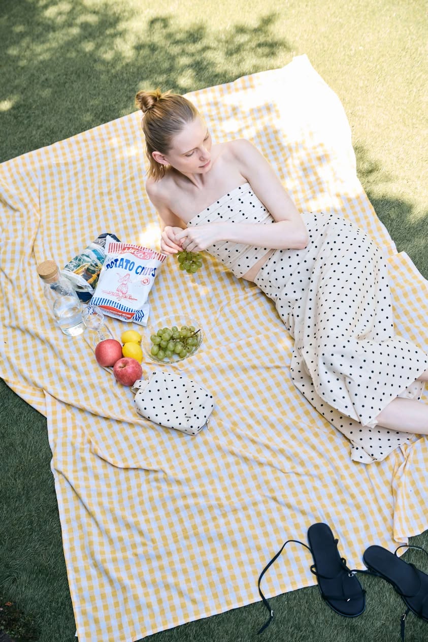 Klarra Cassis picnic styling with polka-dot pouch and black flip-flops