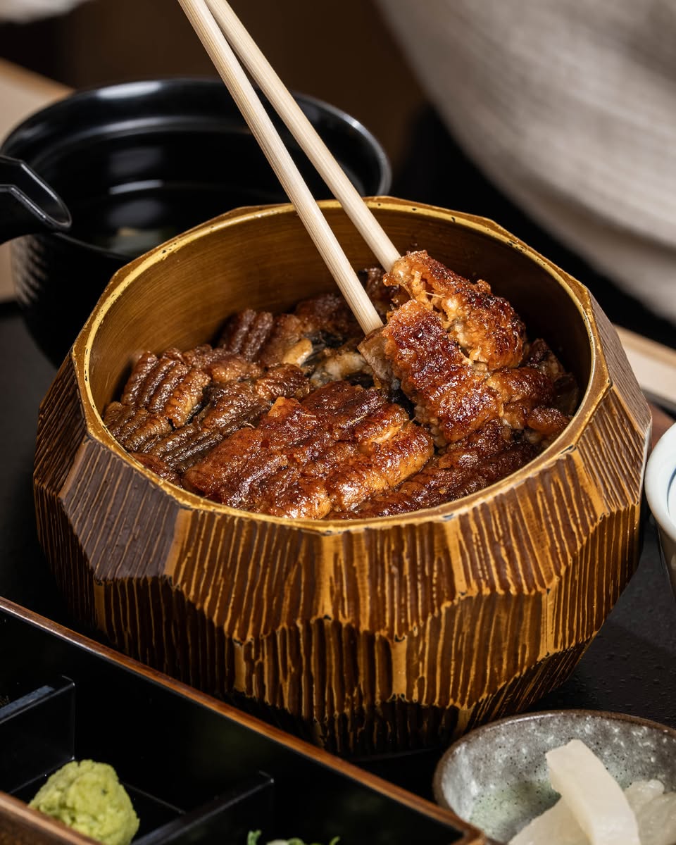 Glazed unagi in a wooden bowl