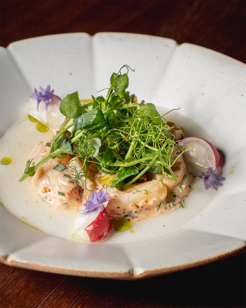 Chefs collaborating during the 6-hands culinary event