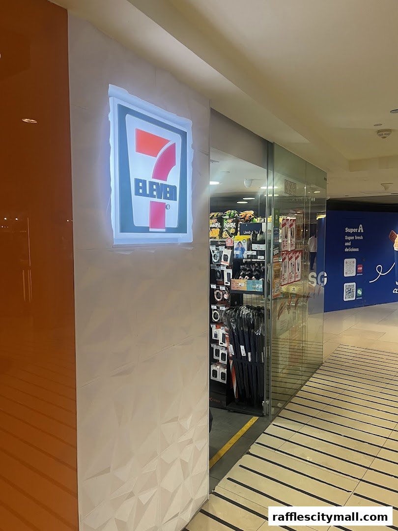 The exterior of a 7-Eleven convenience store with its illuminated logo and display of goods inside.