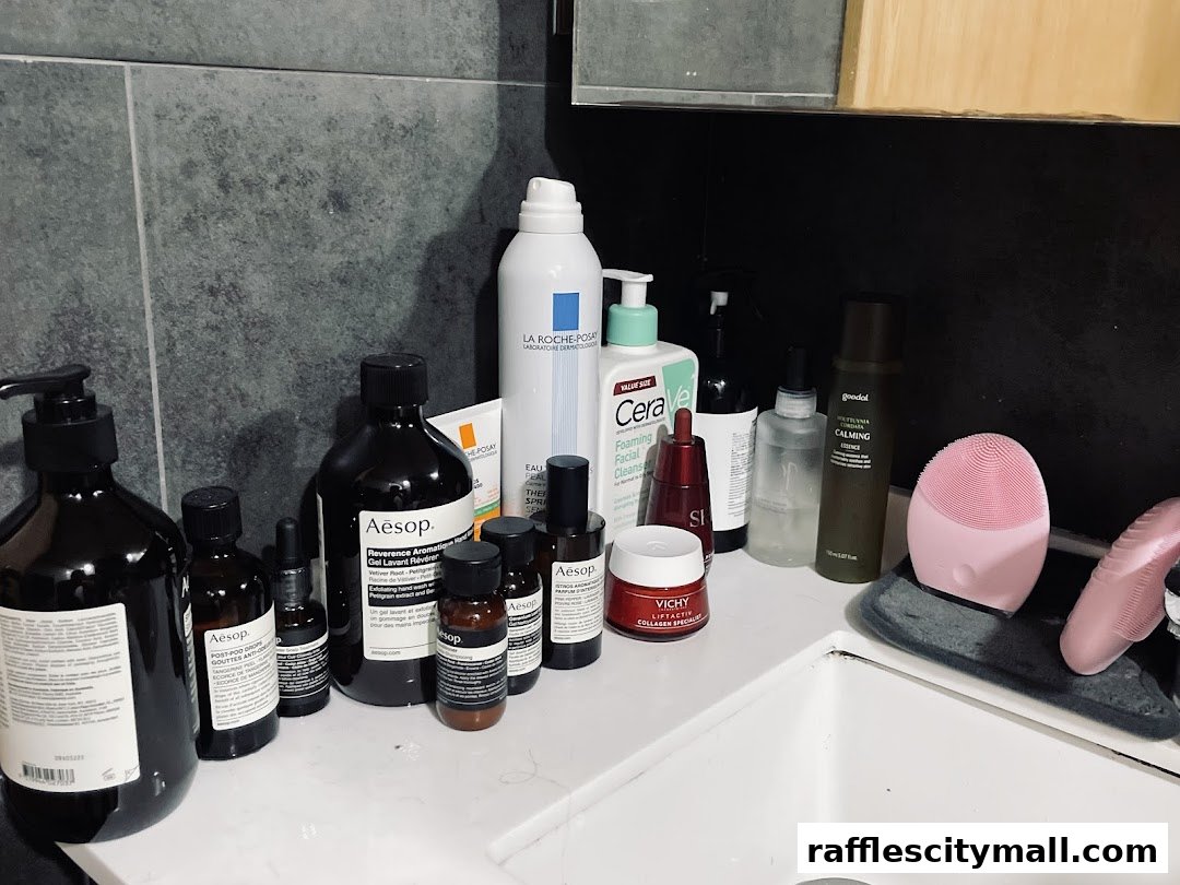 A collection of Aesop and other skincare products arranged on a bathroom counter.