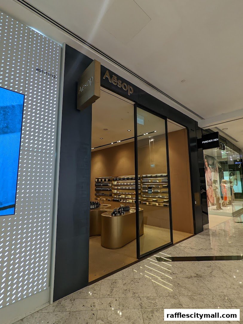 The exterior of an Aesop shop with a clean, modern design and products displayed inside.