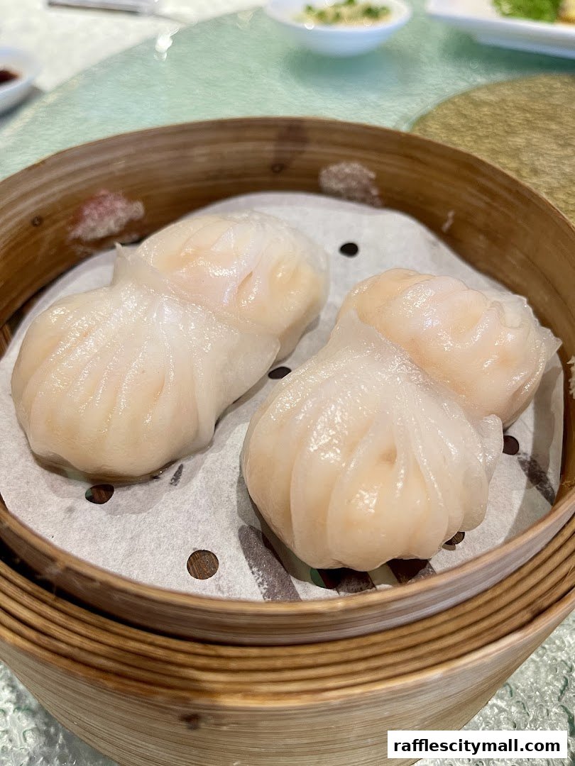 Close-up of delicate steamed dumplings in a bamboo steamer basket.