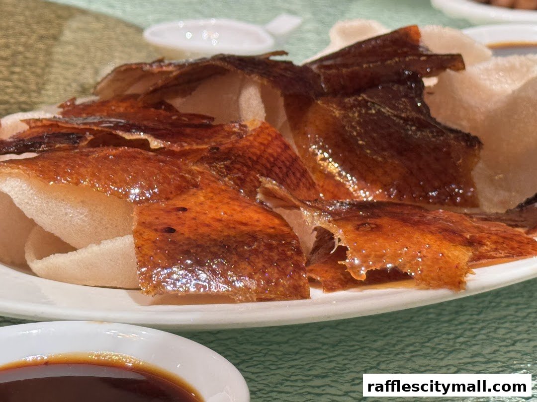 Crispy Peking duck skin served with prawn crackers and dipping sauce.