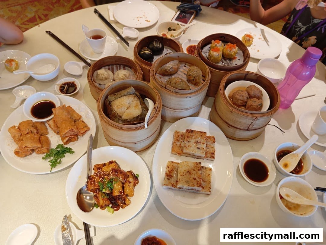 A table laden with various delicious dim sum dishes, including dumplings, spring rolls, and meat dishes.