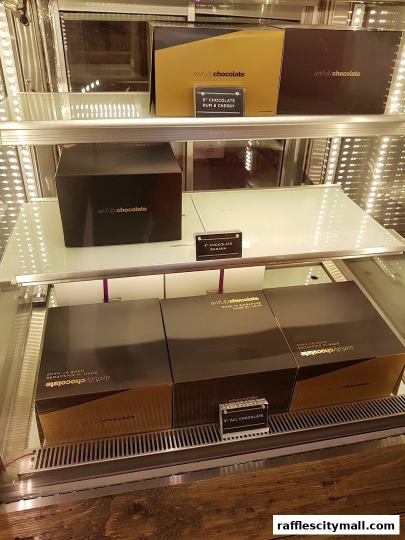 Display case filled with Awfully Chocolate cakes in various flavors and sizes.