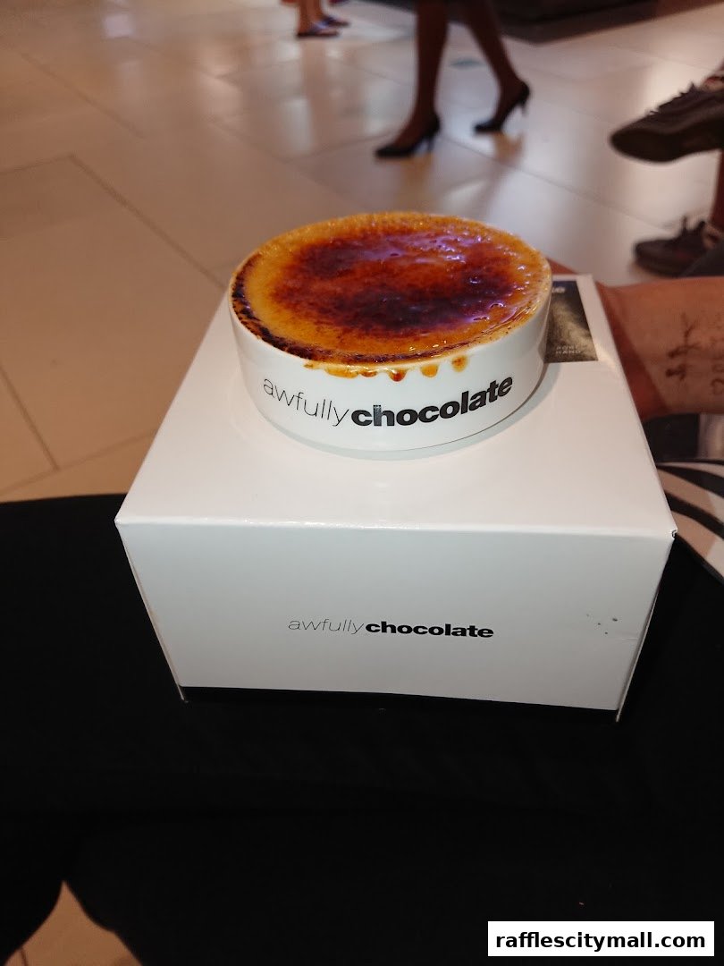 A crème brûlée dessert from Awfully Chocolate on a white box.