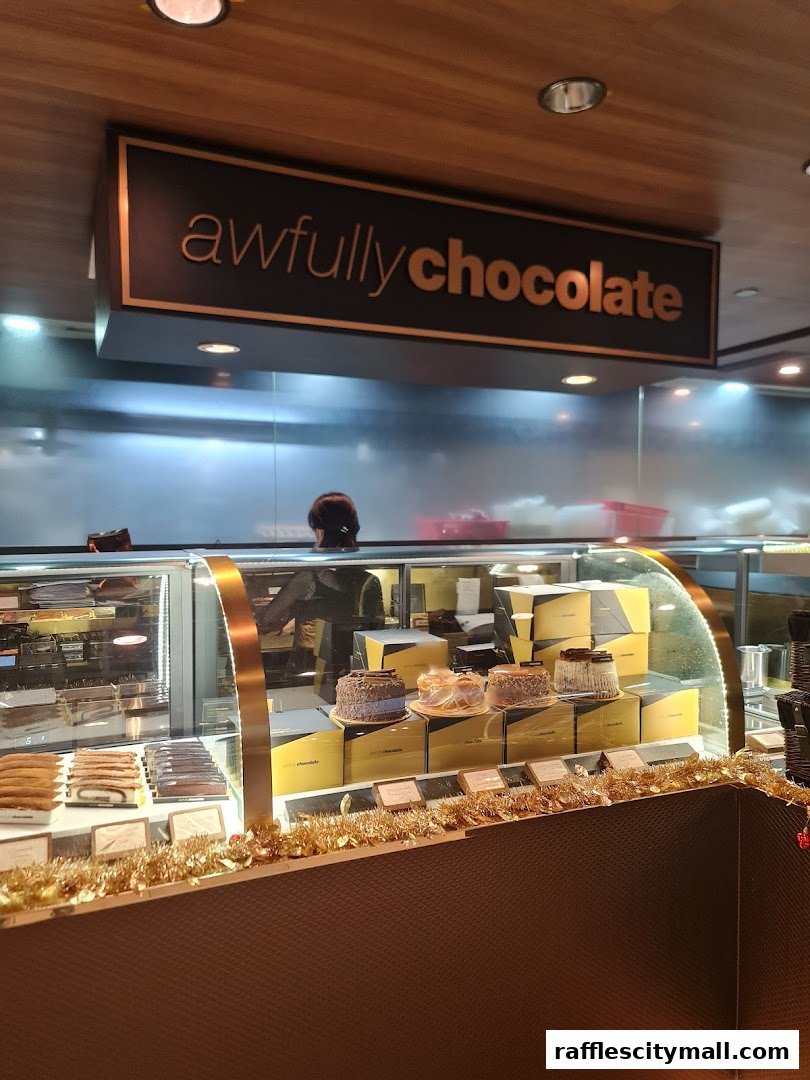 A display case filled with cakes and chocolates at Awfully Chocolate.