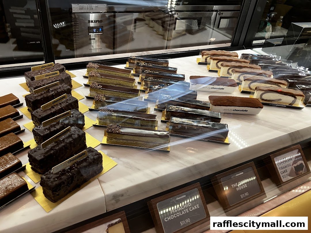 A display case filled with various chocolate cakes and desserts from Awfully Chocolate.