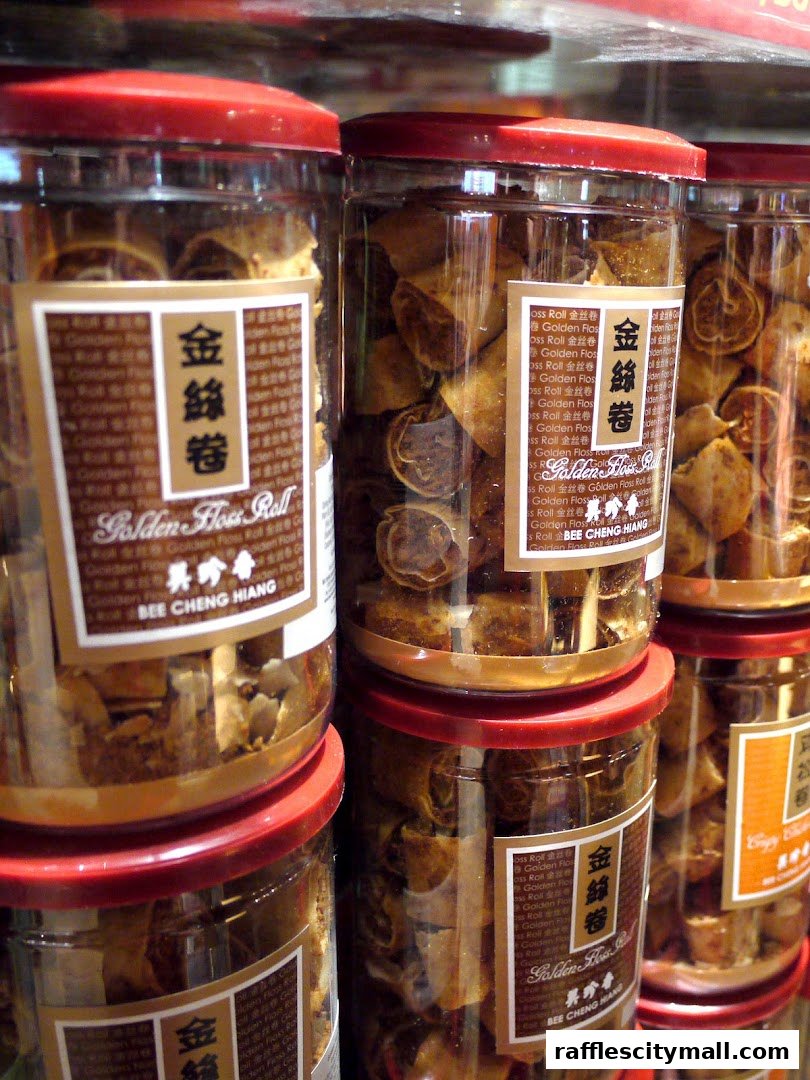 Jars of Golden Floss Roll snacks from Bee Cheng Hiang are neatly stacked.