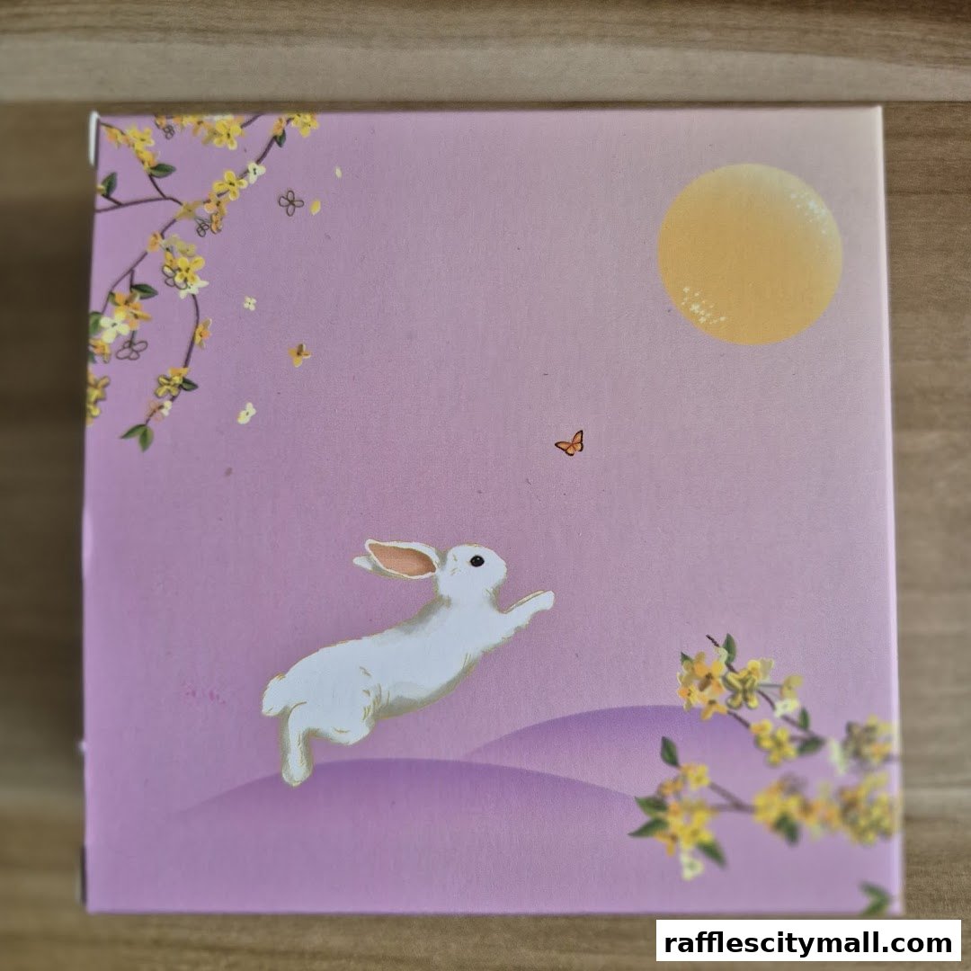 A pink box with a white rabbit, moon, and floral design.
