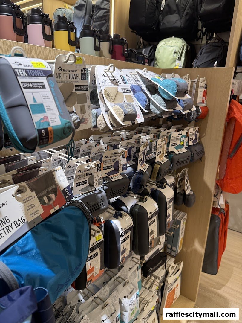 A display of travel towels and accessories from Sea to Summit in a retail store.