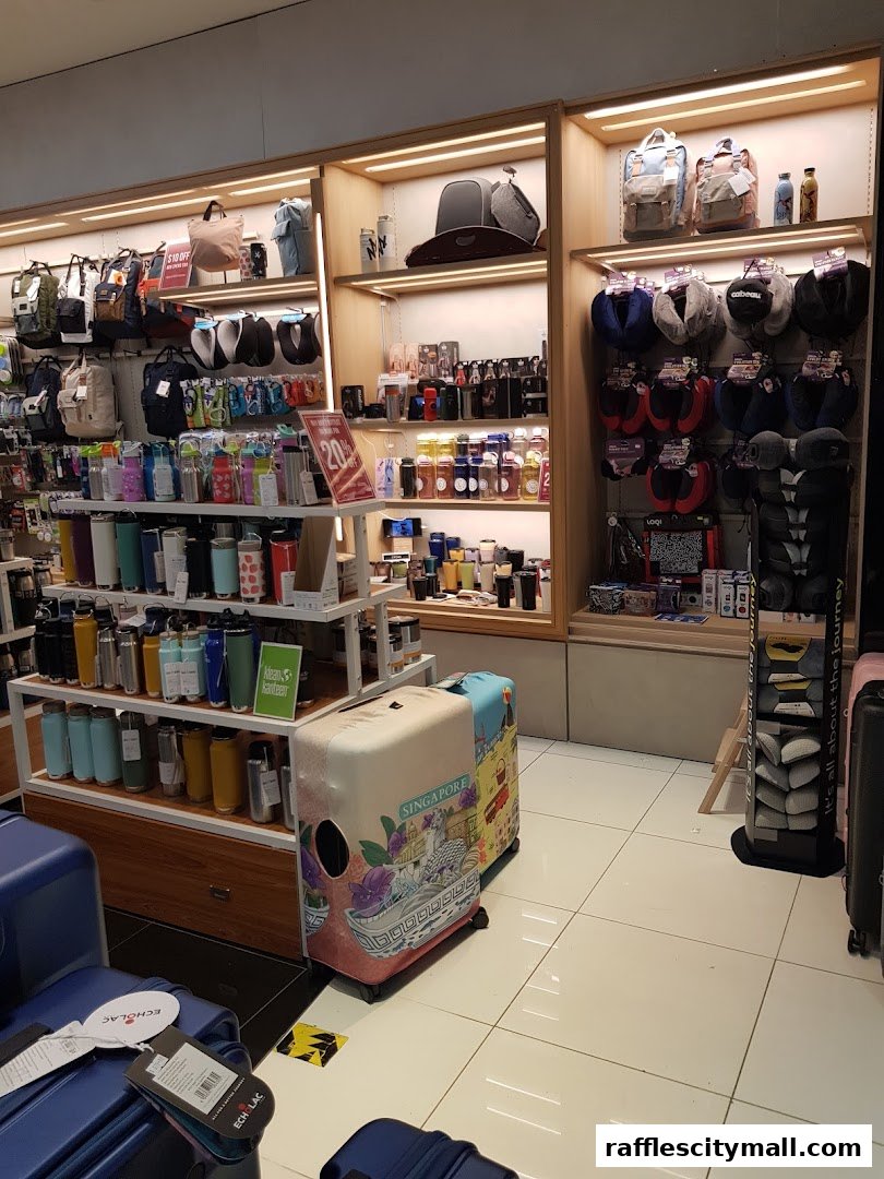 A retail shop interior displaying travel accessories like backpacks, water bottles, and neck pillows.