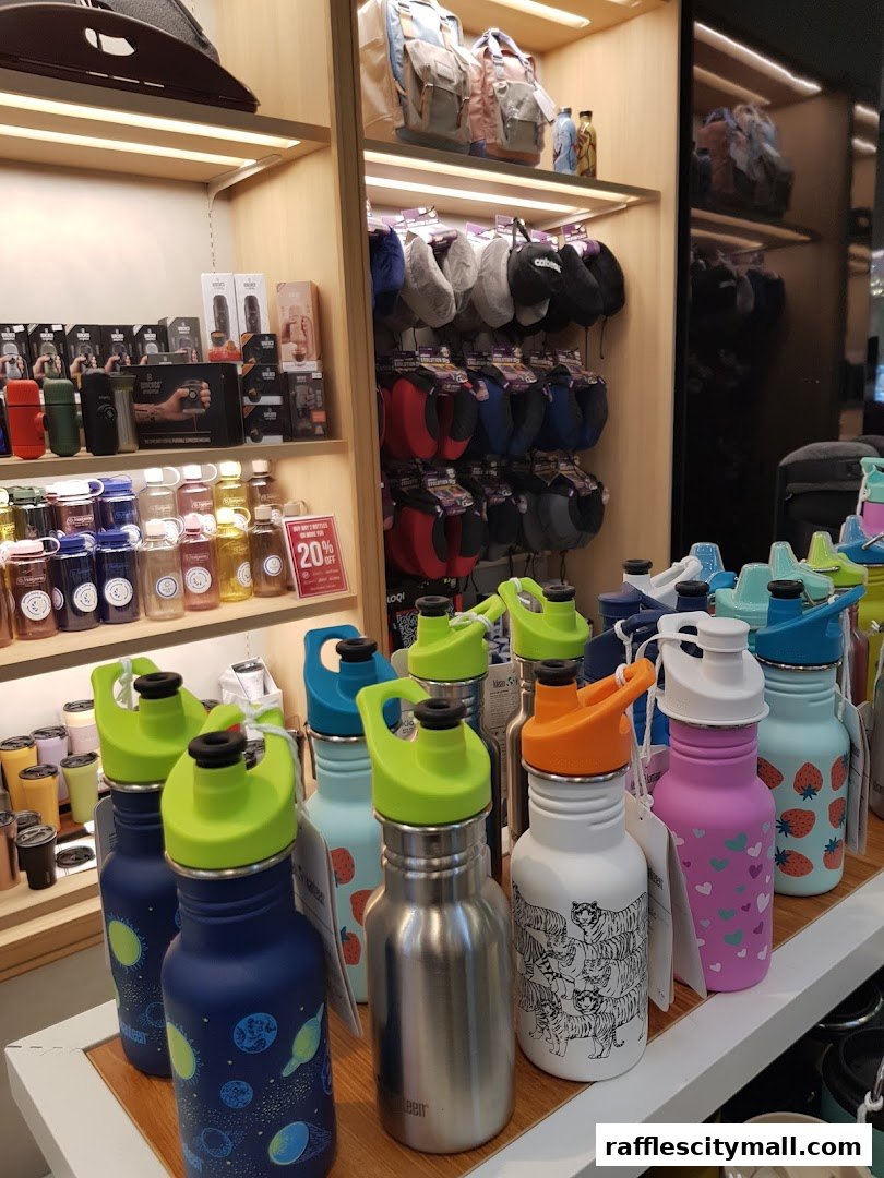 A display of colorful water bottles and travel accessories in a retail store.