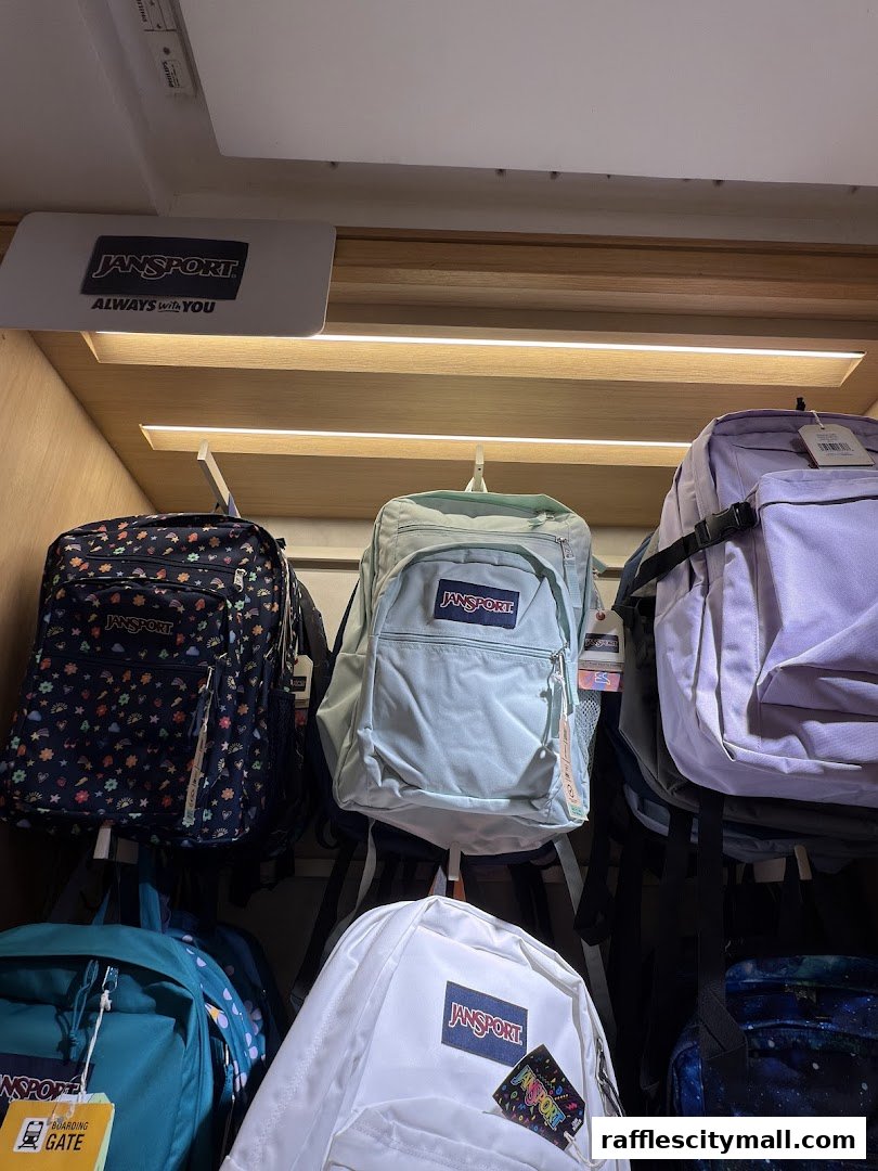 A display of Jansport backpacks in various colors and patterns.
