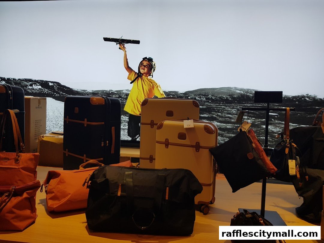 A display of various travel bags and suitcases, with a backdrop featuring a child holding a toy airplane.