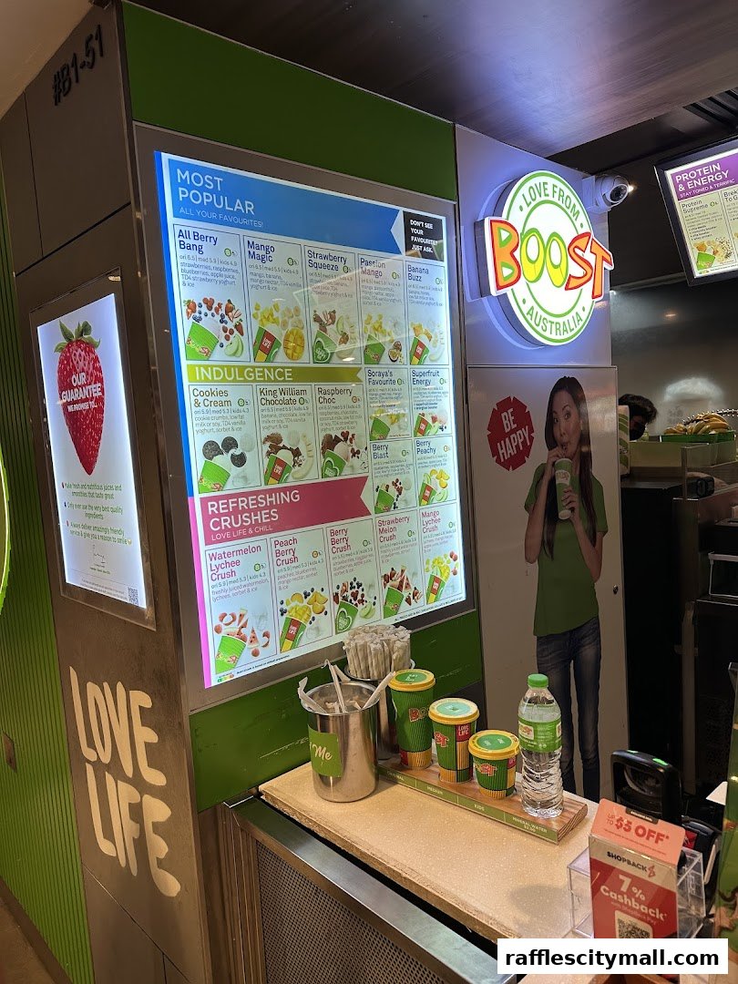 A Boost Juice shop counter displaying a vibrant menu of smoothies and drinks.