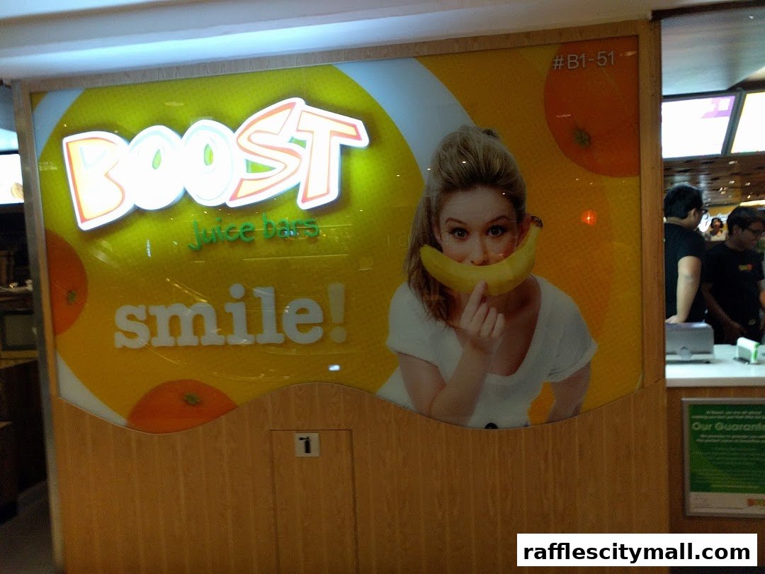 Boost Juice shop front with a smiling woman holding a banana and promotional text.