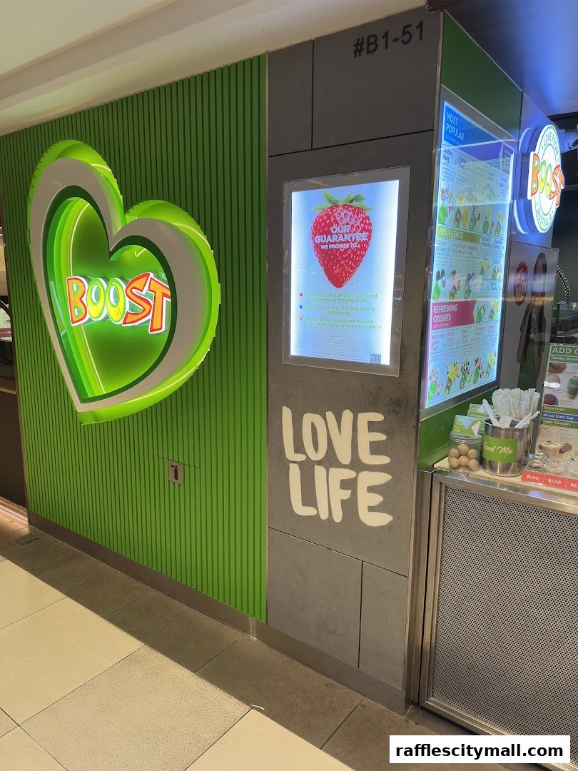 Boost Juice shop front with a large neon heart logo and a menu display.