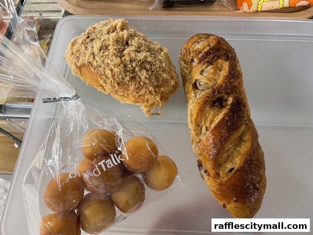 A close-up shot of three freshly baked bread items from BreadTalk.