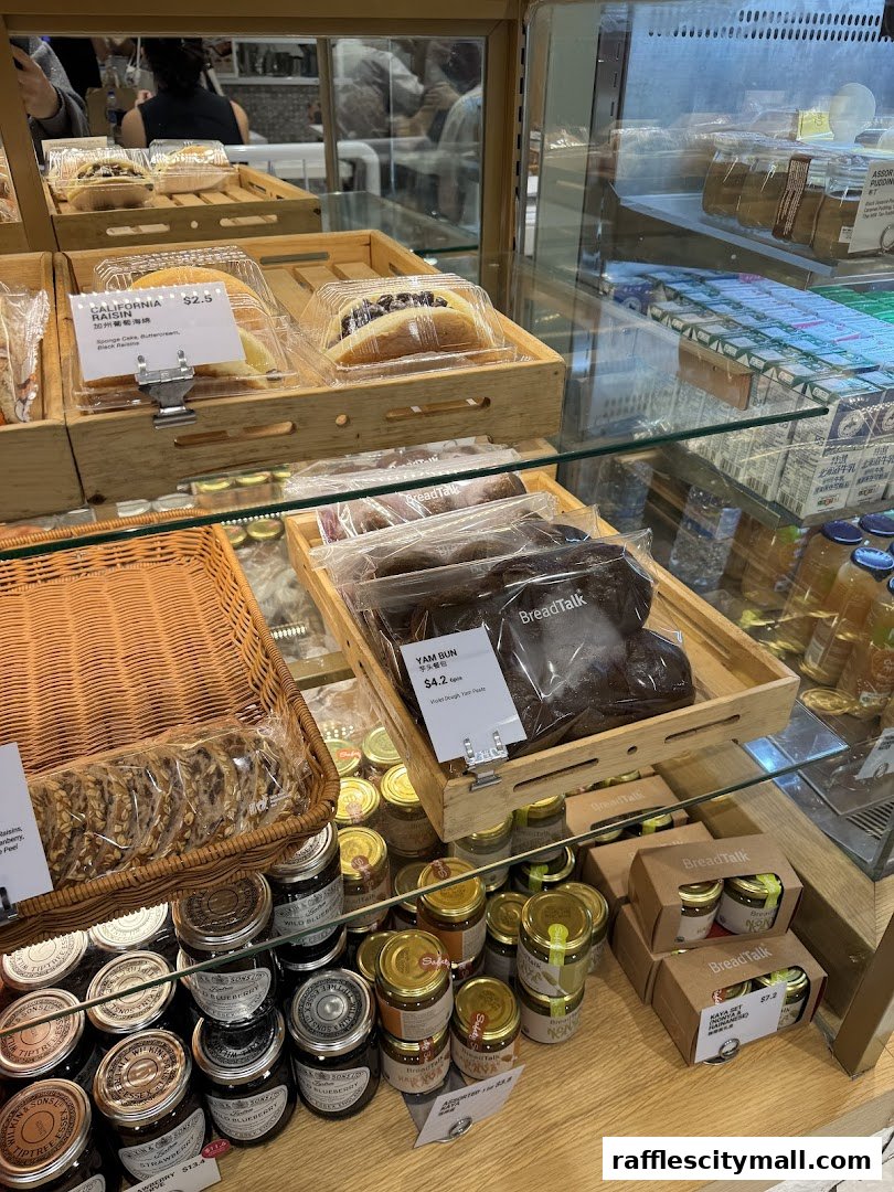 A display of freshly baked bread, buns, jams, and puddings at BreadTalk.