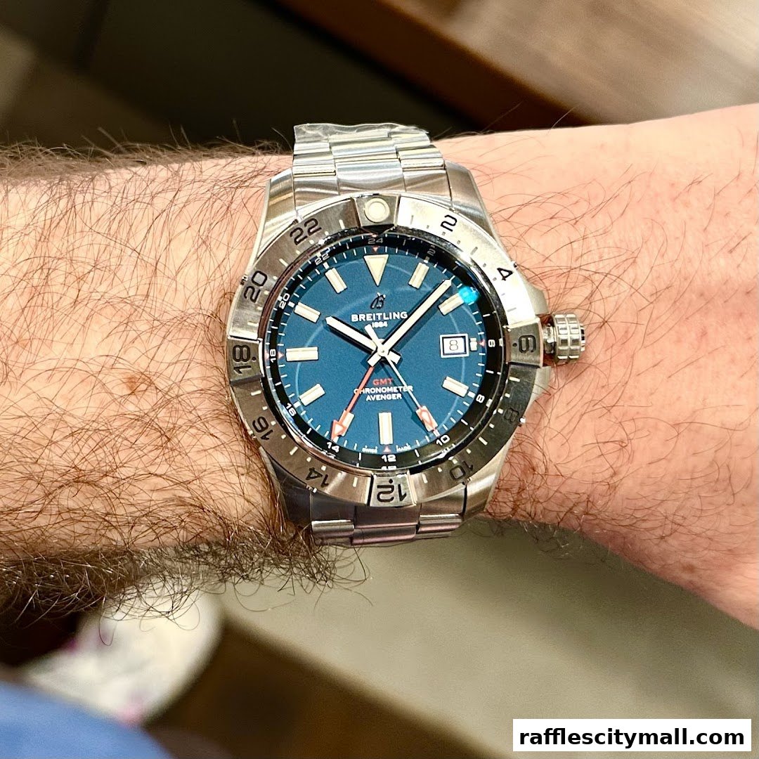 A close-up shot of a Breitling Avenger GMT Chronometer watch on a person's wrist.