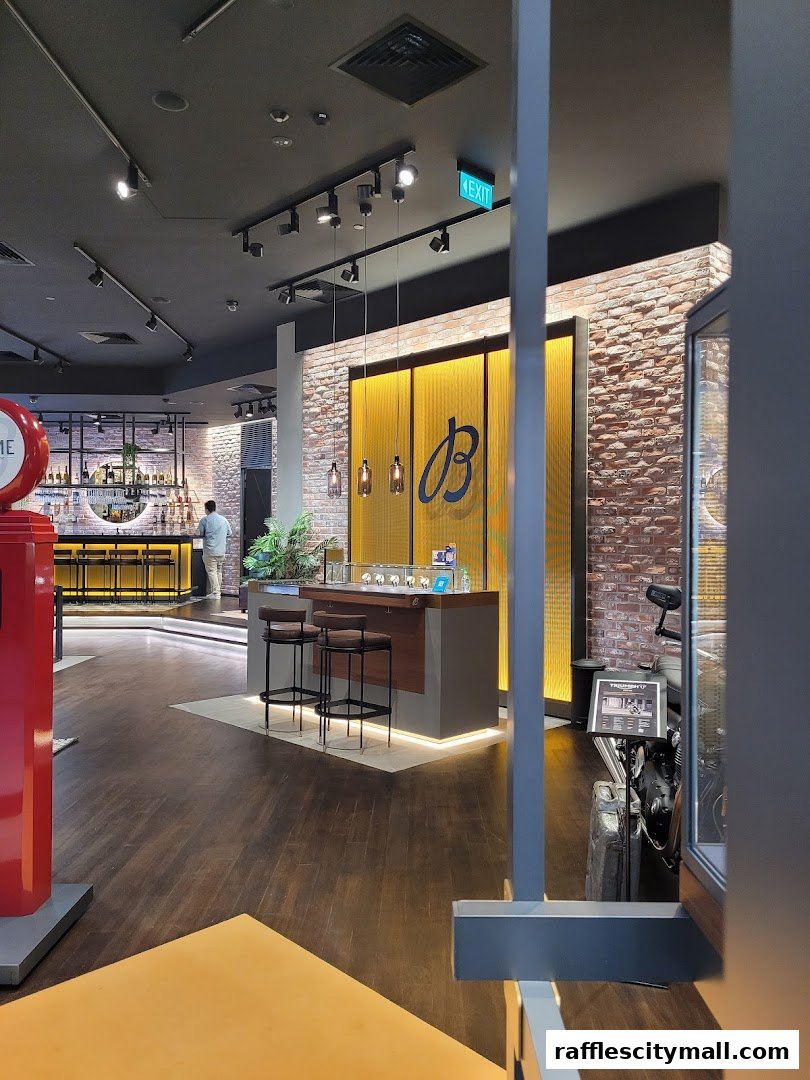 Interior of a Breitling boutique with a display counter, bar area, and a motorcycle.
