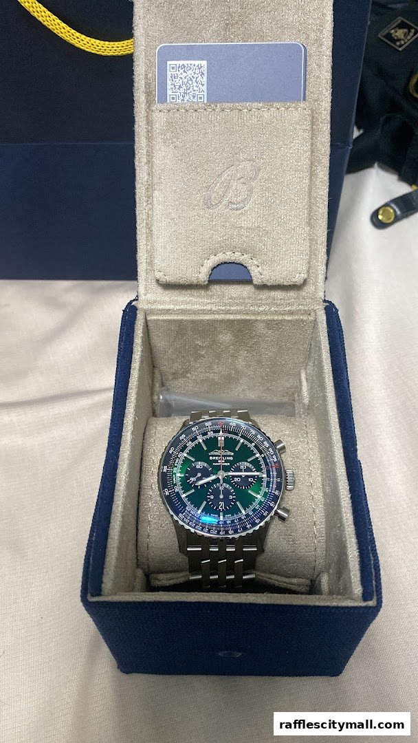 A Breitling watch in its presentation box with a QR code card.