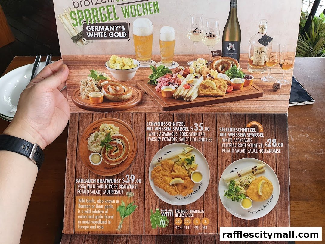 A menu featuring German dishes, including bratwurst, schnitzel, and asparagus, with accompanying drinks.