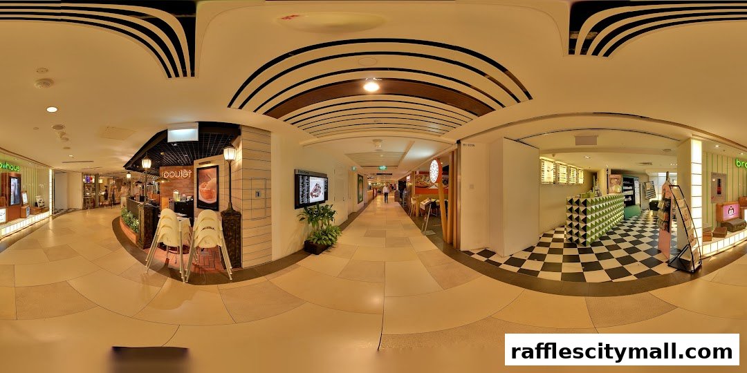 A panoramic view of a shopping mall corridor with various shops, including Browhaus.