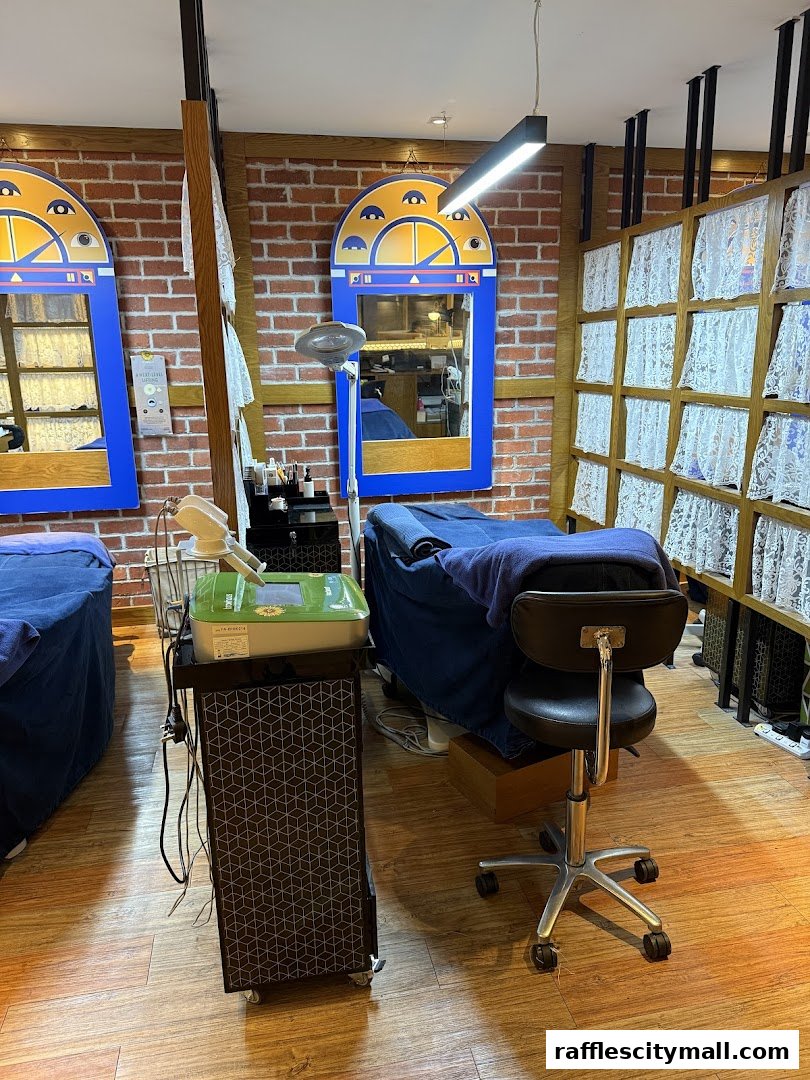 Interior view of a beauty salon with treatment beds, mirrors, and equipment.