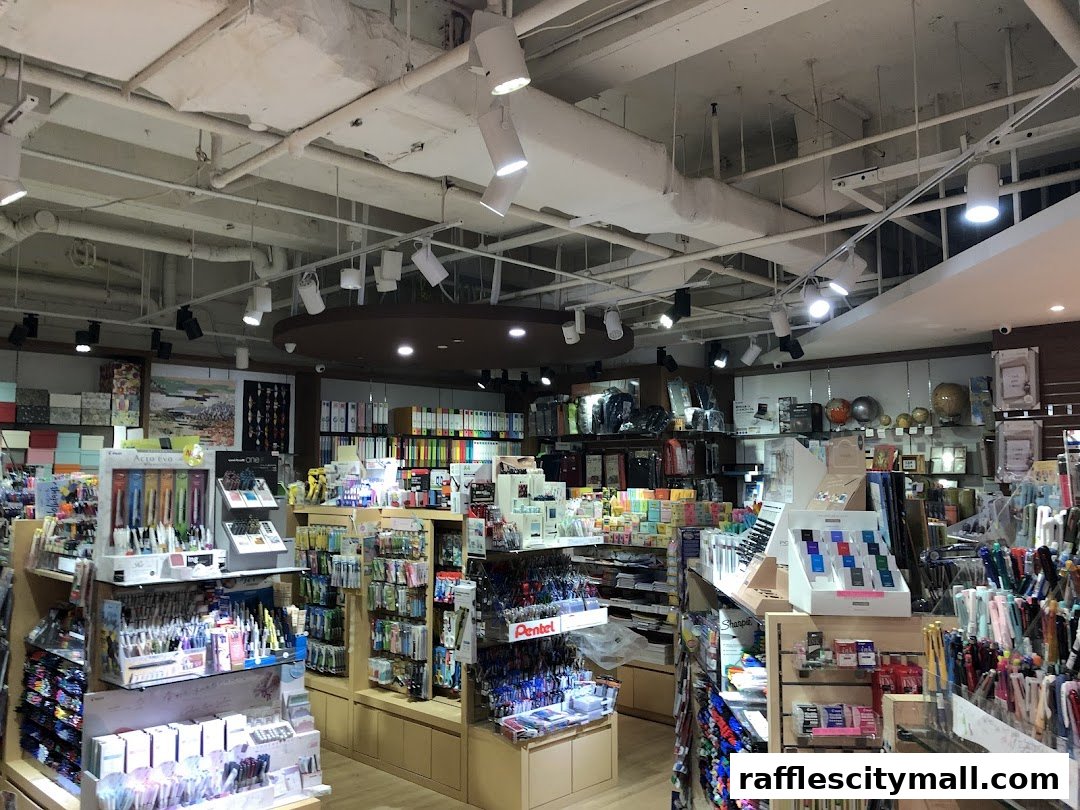 Interior view of a well-stocked stationery and art supply store with shelves of pens, notebooks, and art materials.