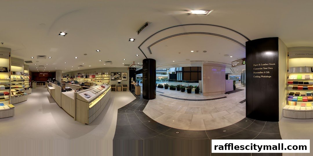 Interior view of a well-lit shop selling paper and leather goods, with displays of notebooks and accessories.