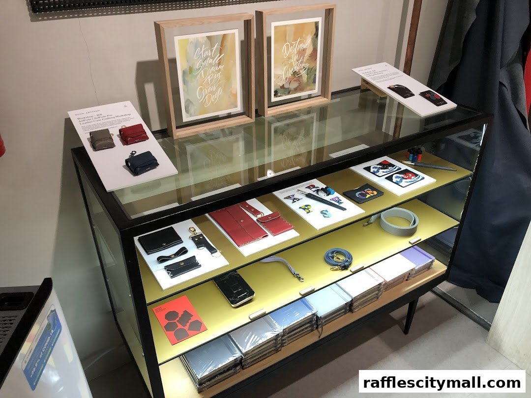 A display case filled with leather goods, notebooks, and artwork.