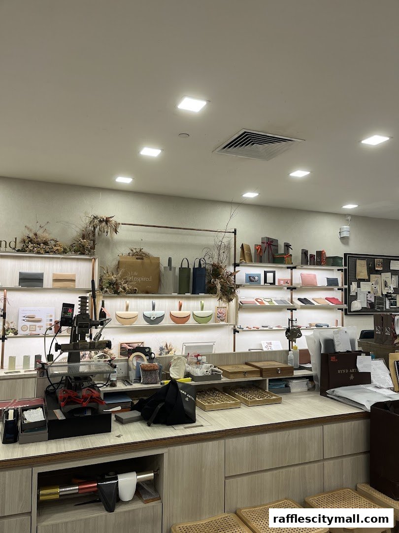 Interior view of a well-lit atelier showcasing leather goods and crafting tools.