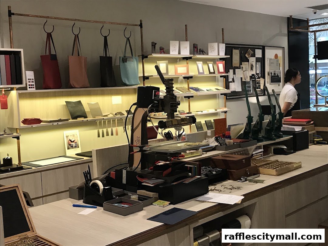 Interior of a workshop with leather goods, tools, and a staff member.