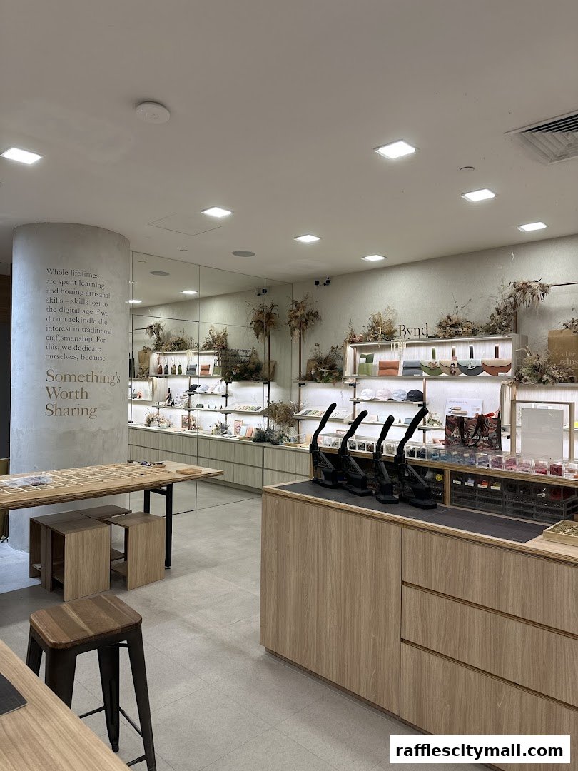 Interior of a modern atelier with display shelves showcasing artisanal products and a central counter.