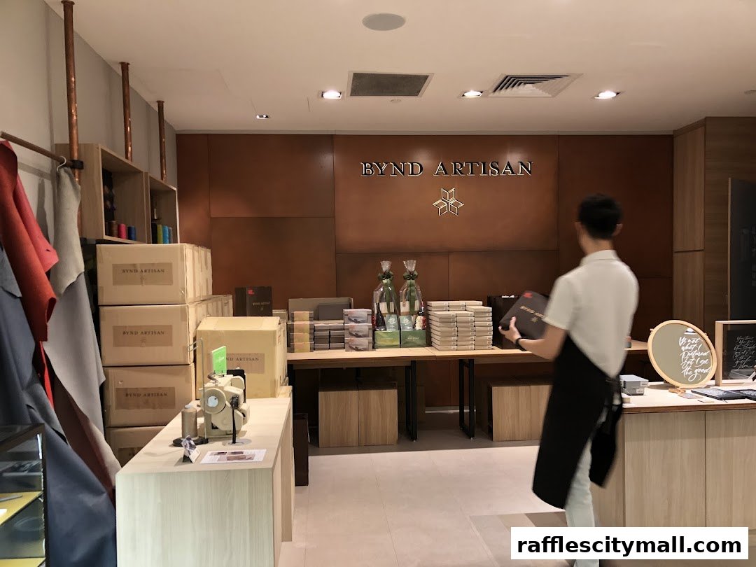 A store interior with leather goods, boxes, and a staff member holding a product.