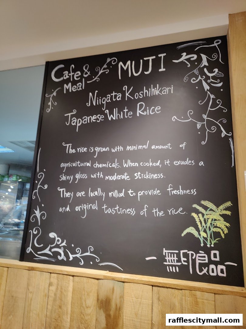 A chalkboard menu at Cafe & Meal MUJI Raffles City highlighting Japanese White Rice.