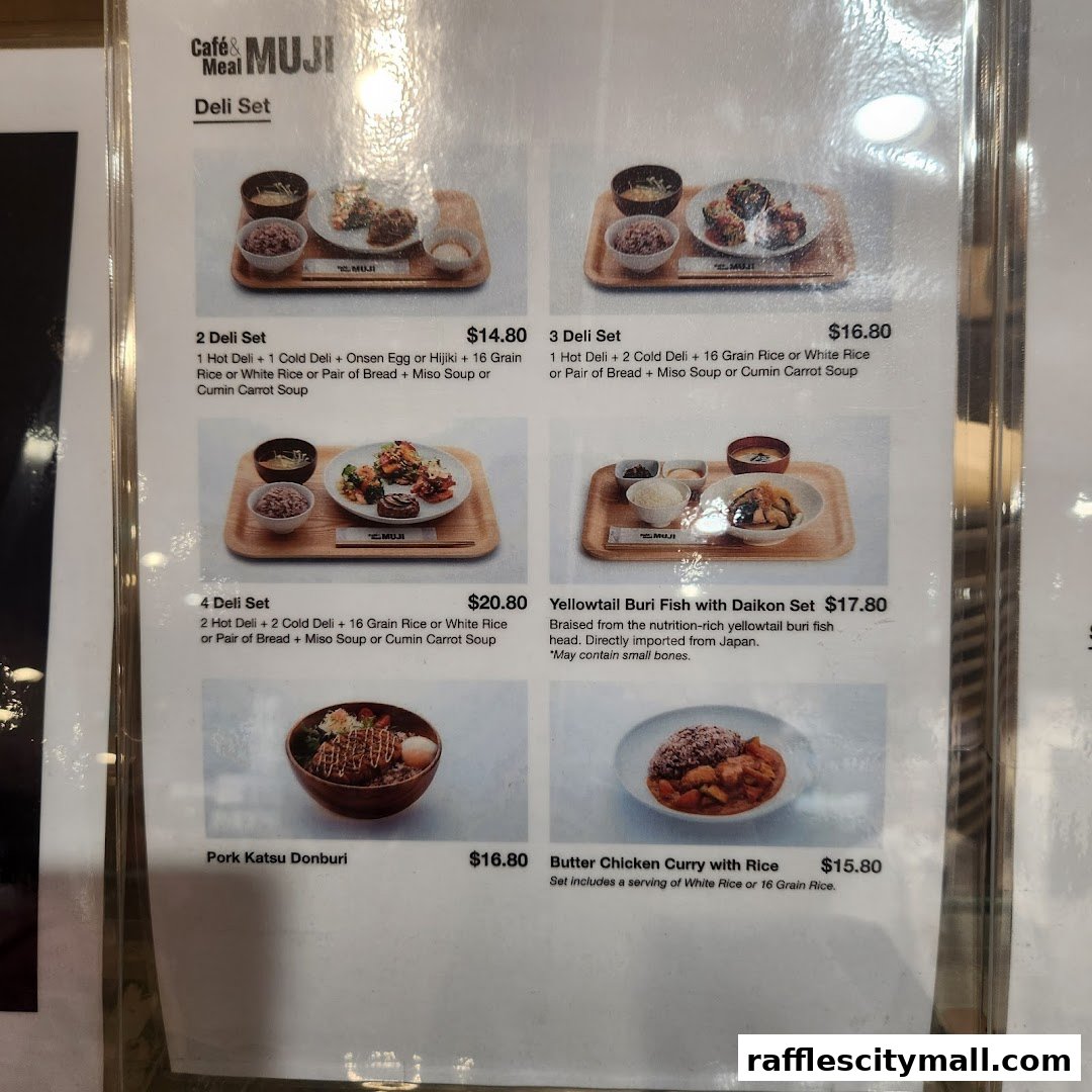 A menu display for CafeMeal MUJI featuring various deli sets and rice dishes.