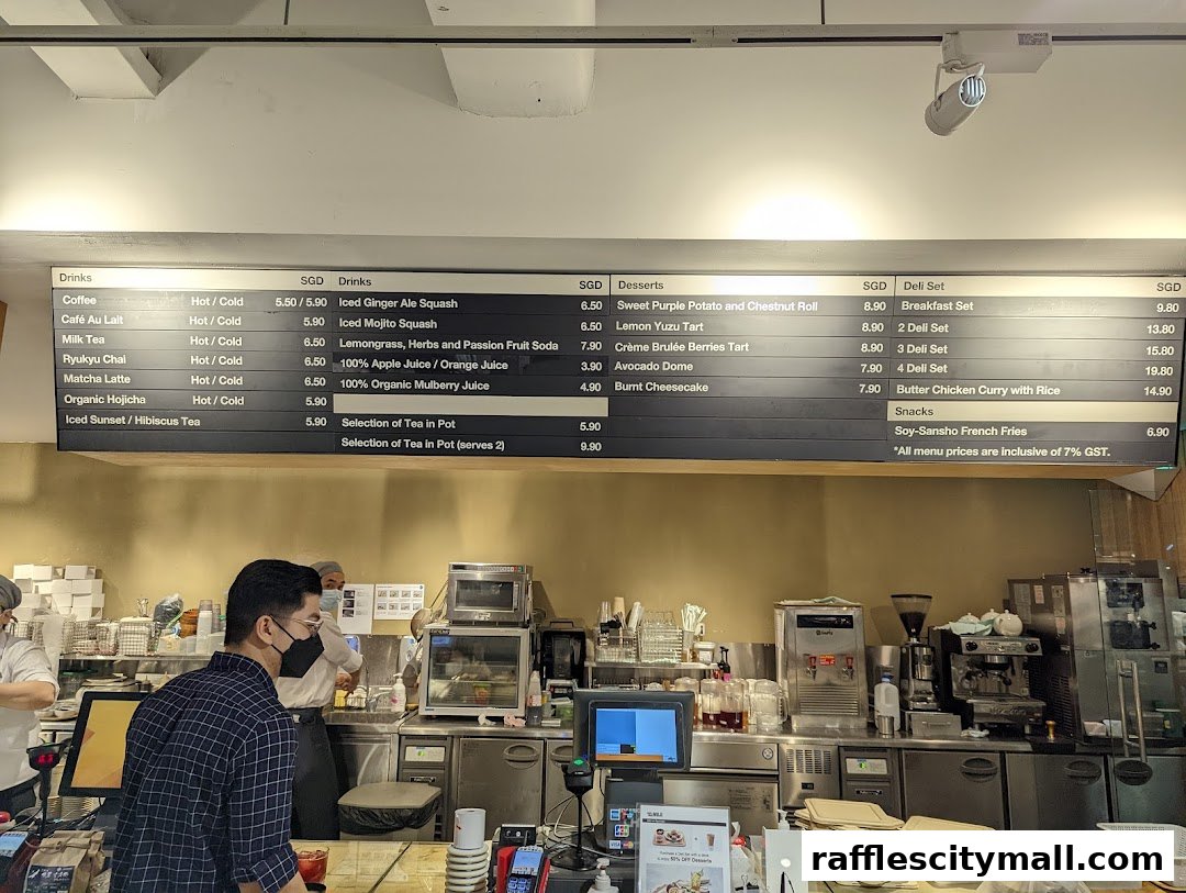 A menu board displaying drinks, desserts, deli sets, and snacks with prices.