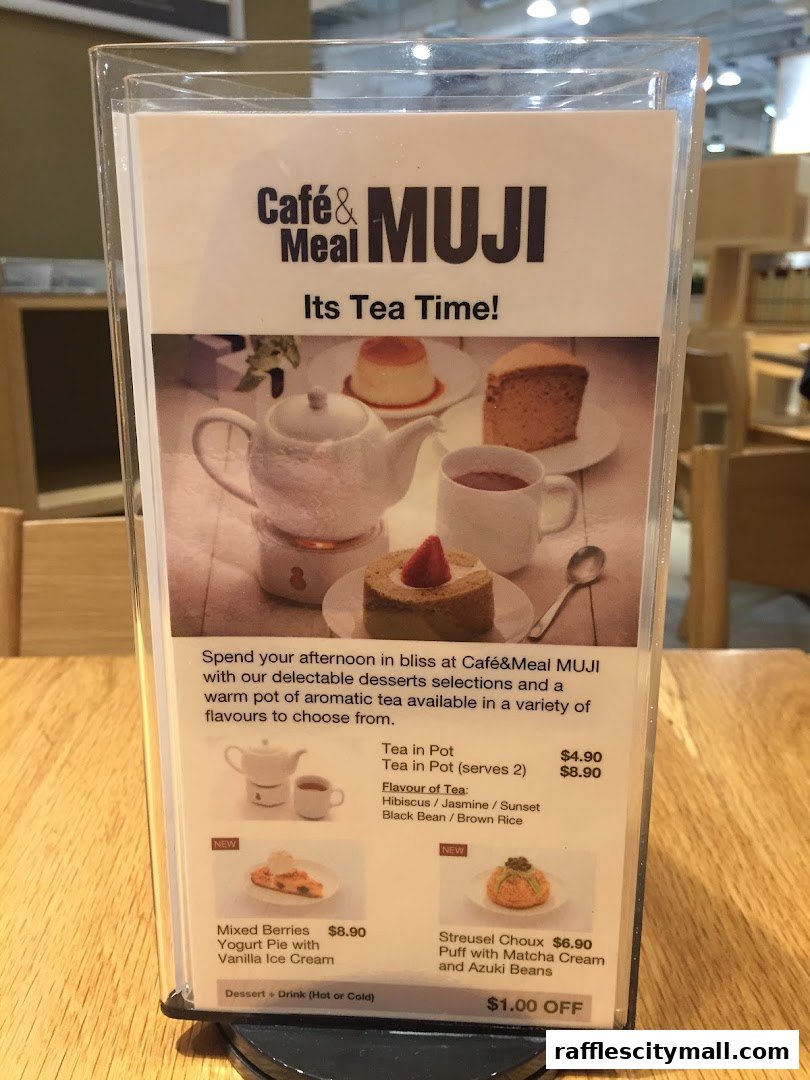 A menu display for Cafe&Meal MUJI featuring tea and dessert options.