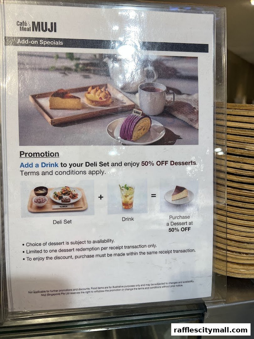 A promotional sign for Cafe & Meal MUJI offering 50% off desserts with a deli set and drink purchase.