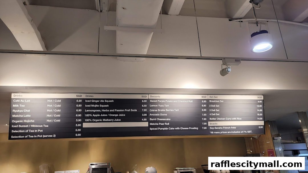A digital menu board displaying drinks, desserts, deli sets, and snacks with prices.