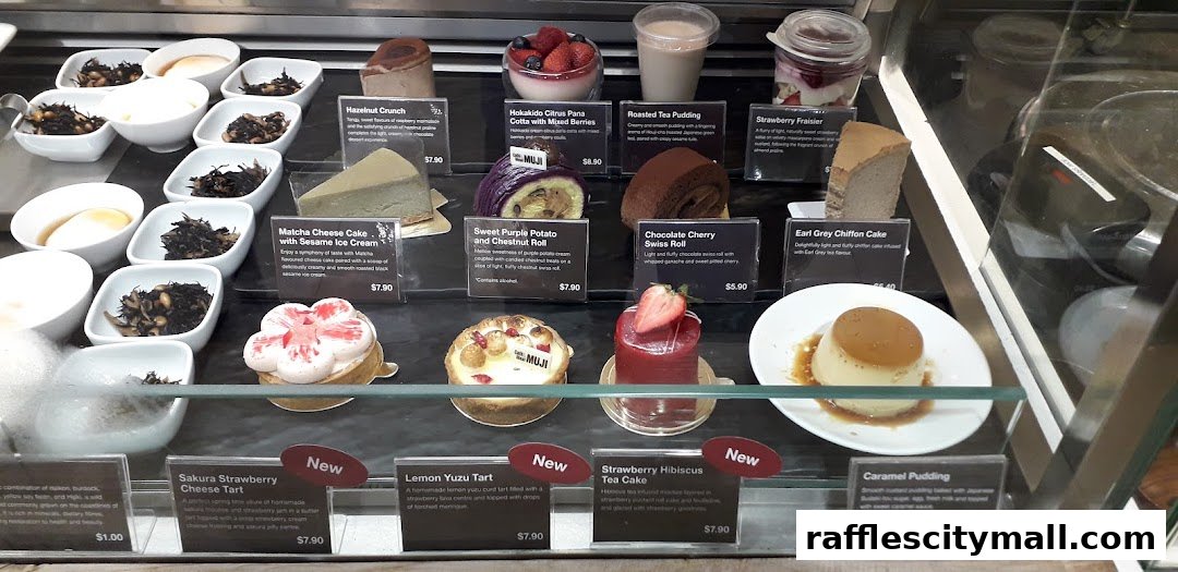 A display case filled with various desserts and pastries from CafeMeal MUJI.