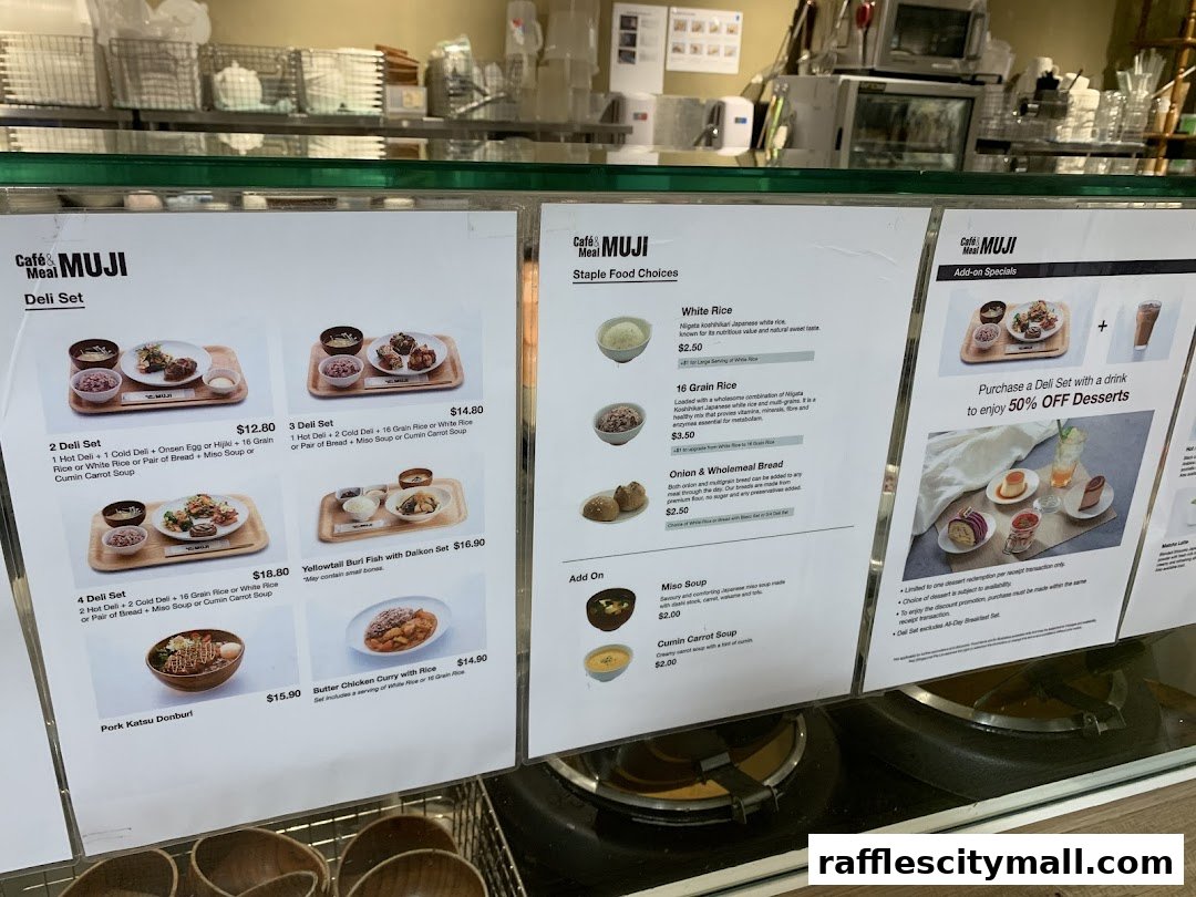 A menu display for Cafe MUJI Raffles City featuring deli sets, staple food choices, and add-ons.