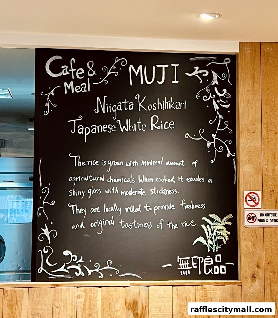 A chalkboard menu at MUJI Cafe & Meal highlighting Niigata Koshikari Japanese White Rice.