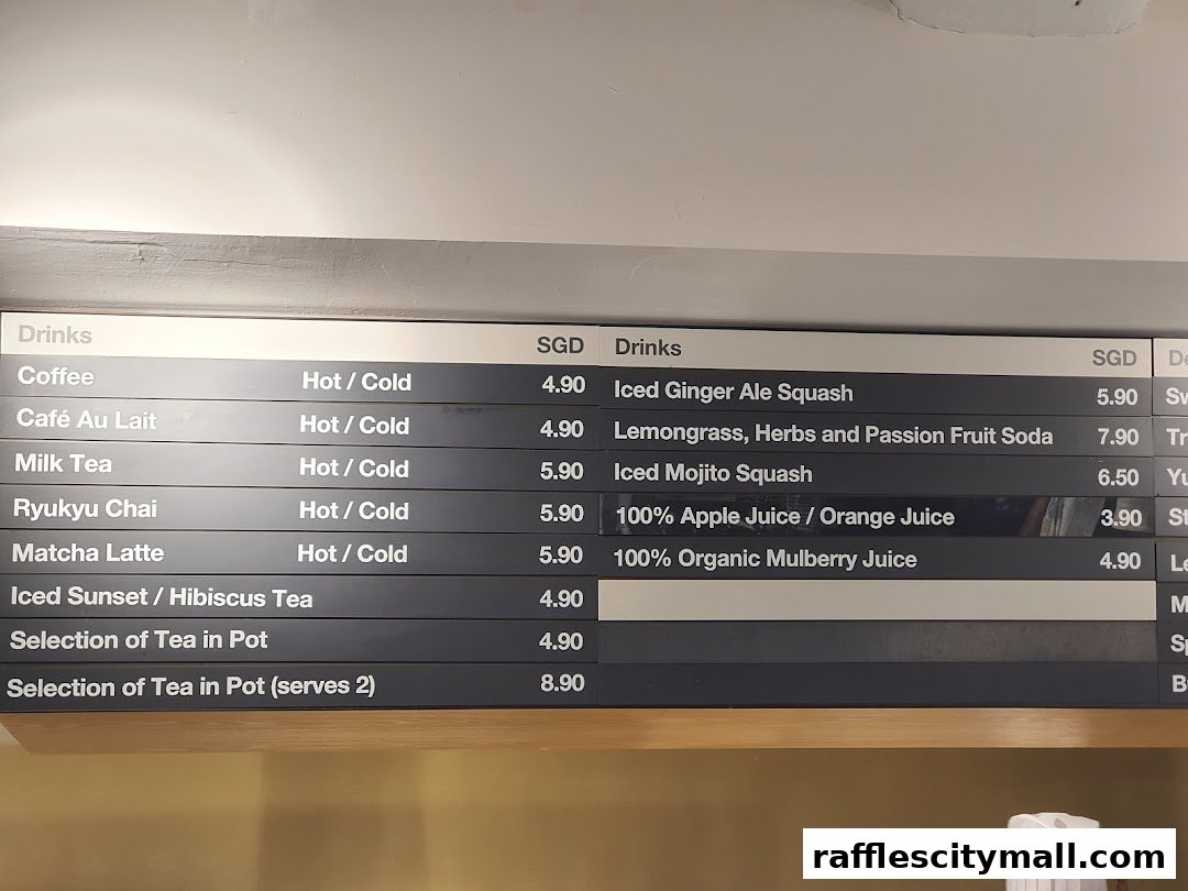 A menu board displaying various drinks and their prices at CaféMeal MUJI Raffles City.