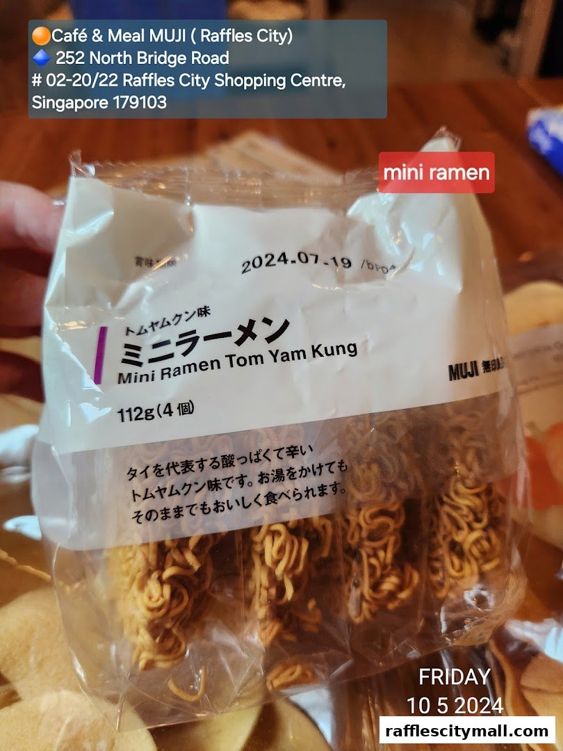 A package of MUJI Mini Ramen Tom Yam Kung with product details and store information.